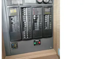 Electrical panel of a 2021 Leopard 50 model, featuring circuit breakers and warning labels.