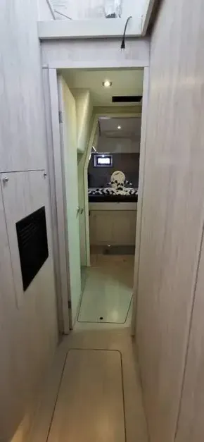 Interior hallway of 2019 Leopard 51 Powercat leading to a cozy bedroom.