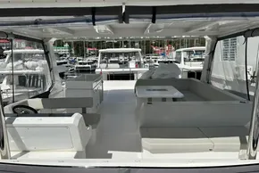 2025 Robertson and Caine Leopard 46 Powercat interior with seating and helm, docked at marina.