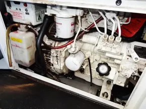 Engine compartment of a 2021 Leopard 40, showcasing mechanical components and fluid reservoirs.