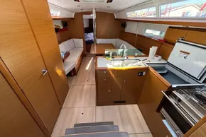 Interior of 2020 Jeanneau Sun Odyssey 389 yacht, featuring modern kitchen and seating area.