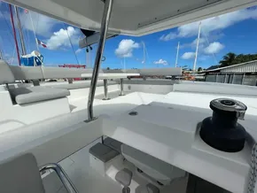 Spacious deck of 2020 Leopard 50 catamaran with seating and clear blue sky.
