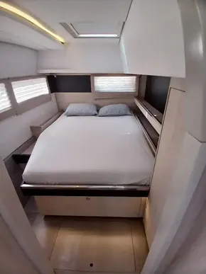 Luxurious cabin interior of 2019 Leopard 45 catamaran with cozy bed and modern design.