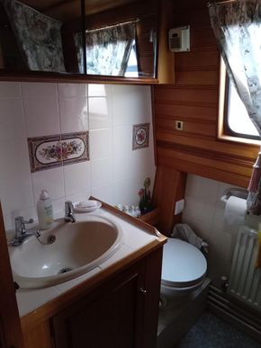 Bathroom with pump out toilet and hip bath