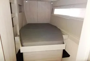 Compact bedroom interior of 2015 Leopard 51 Powercat with a cozy bed.