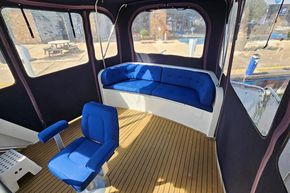 Interior of 2005 Stevens 1200 Vlet boat with blue seating and wooden flooring.