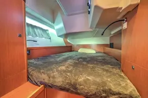Cozy cabin interior of 2013 Beneteau Oceanis 41 sailboat with plush bedding.