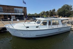 2024 Piper 12c boat docked at marina under clear blue sky.