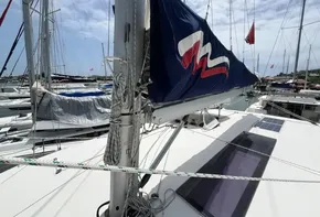 2019 Leopard 45 sailboat docked at a marina with sails partially raised.