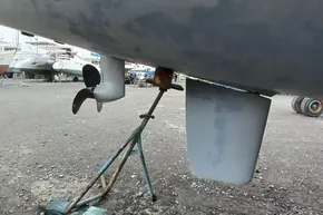 2024 Lagoon 42 catamaran underbody with propeller and rudder in a boatyard.