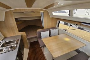 Interior of 2023 Balt 818 Titanium yacht with cozy seating and modern kitchenette.