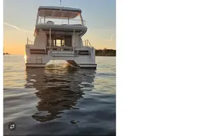 2024 Leopard 40 Powercat yacht on calm water at sunset.