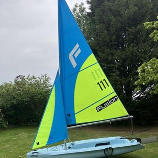 Fusion sailing dinghy with trolley and cover with option for road base