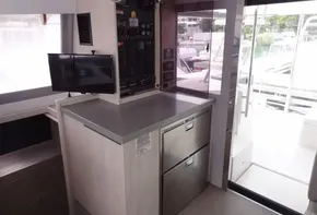 Interior of 2020 Leopard 43 Powercat with control panel, TV, and stainless steel drawers.