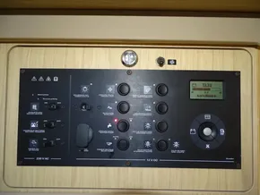 Control panel of a 2017 Beneteau Oceanis 45 sailboat, featuring various switches and a digital display.