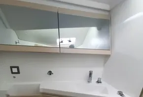 Modern bathroom in 2020 Beneteau Oceanis 46.1 yacht with sleek fixtures and wooden accents.