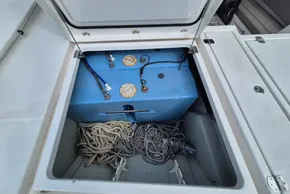 Open storage compartment on Leopard 45 yacht, featuring ropes and a blue tank.
