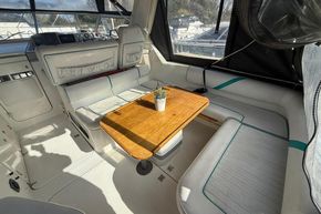 Interior of 1991 Sealine 290 Ambassador boat with seating and wooden table.