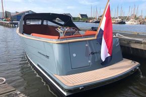 2026 Enkhuizensloep 680 Tender boat docked, featuring sleek design and Dutch flag.