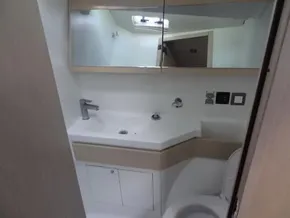 Modern bathroom in 2020 Beneteau Oceanis 46.1 yacht with sleek fixtures and mirror.