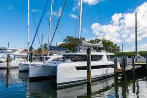 2025 Leopard 46 catamaran docked at marina under clear blue sky.