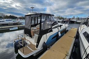 2023 Balt 818 Titanium boat docked at marina under cloudy sky.
