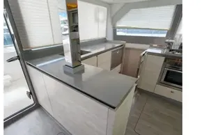 Modern kitchen interior on 2020 Leopard 50 yacht, featuring sleek countertops and ample natural light.