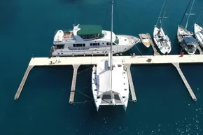 Aerial view of 2024 Lagoon 42 catamaran docked at marina with other boats.