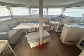 Interior of 2024 Lagoon 42 catamaran with modern seating and navigation area.
