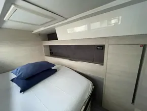 Modern bedroom interior in a 2020 Leopard 50 yacht, featuring sleek design and comfortable bedding.