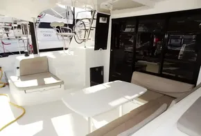 Spacious cockpit of a 2020 Lagoon 42 catamaran with seating and dining area.