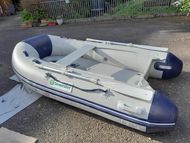 Talmex 2.5M inflatable tender.  Optional Honda 2.3 outboard engine