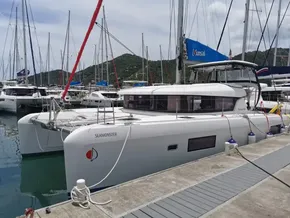 2020 Lagoon 42 catamaran docked at marina with scenic mountain backdrop.