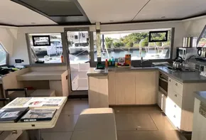 Modern kitchen interior of 2021 Leopard 45 catamaran with scenic marina view.