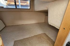 Interior cabin space of a 1998 Maxum 2400 SCR boat, featuring carpeted flooring.