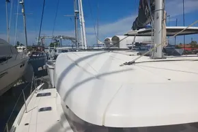 2024 Lagoon 42 catamaran docked at marina under clear blue sky.