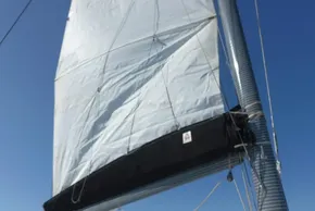 Sail of a 2017 Lagoon 42 catamaran against a clear blue sky.