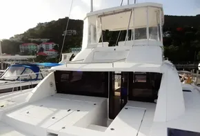 2017 Leopard 43 Powercat yacht docked at a marina with scenic hillside background.