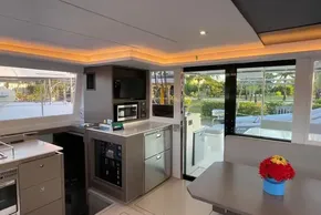 Luxurious interior of 2022 Leopard 42 yacht with modern kitchen and dining area.