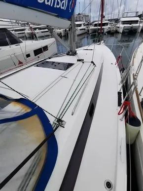 Jeanneau Sun Odyssey 410 sailboat, 2020 model, docked in a marina with other boats.