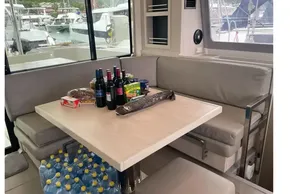 Interior of 2020 Leopard 40 yacht with dining table, beverages, and snacks.