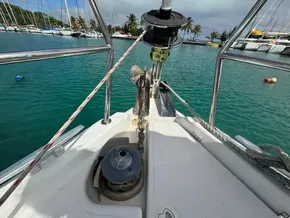 Bow of 2019 Jeanneau Sun Odyssey 440 yacht in marina, with anchor and ropes visible.