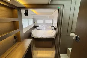 Luxurious bedroom interior of 2024 Leopard 40 Powercat yacht with modern design and cozy bedding.