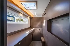 Modern interior of 2025 Leopard 46 yacht with sleek wood paneling and natural light.