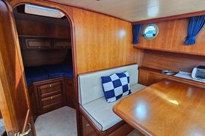 Cozy interior of 2005 Stevens 1200 Vlet boat with wood finish and seating area.
