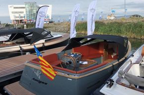 2026 Enkhuizensloep 680 Tender boat docked with flags and banners displayed.