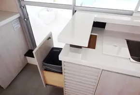 Modern kitchen area in a 2015 Leopard 51 Powercat yacht with open drawer.