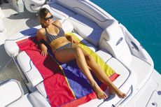 Crownline Deck Boat 260 EX - The aft bench seat folds down to form a comfortable sunpad