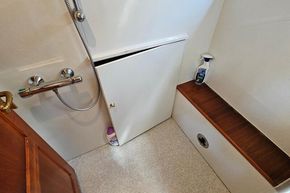 Bathroom interior of 2005 Stevens 1200 Vlet boat with shower and cleaning supplies.