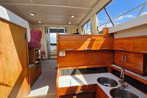 Interior of 1989 Princess 35 Flybridge yacht with wooden cabinetry and dual sinks.